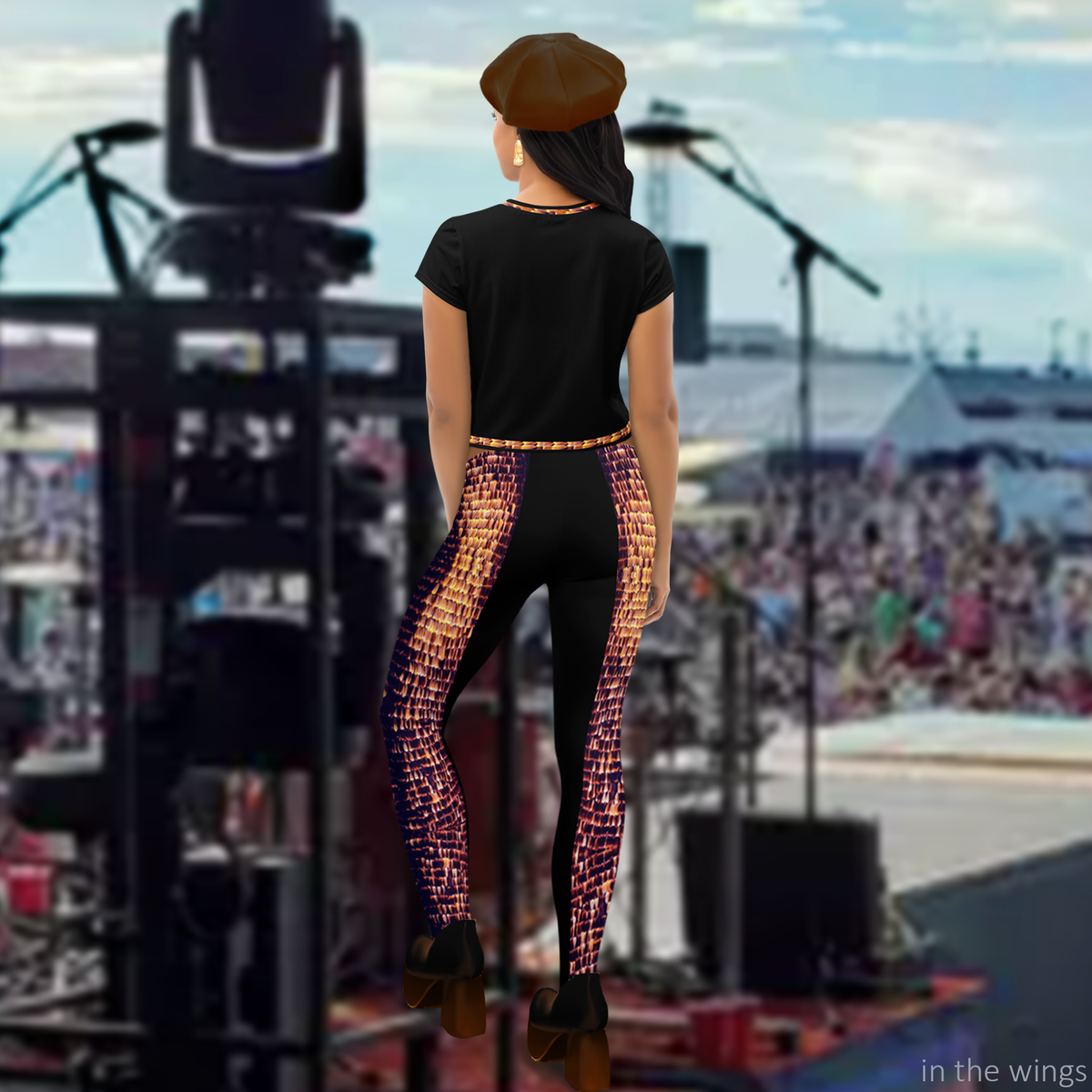 Back view of model wearing DESTINY black crop top with corset inspired design, checking the audience from the wings
