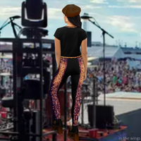 Back view of model wearing DESTINY black crop top with corset inspired design, checking the audience from the wings