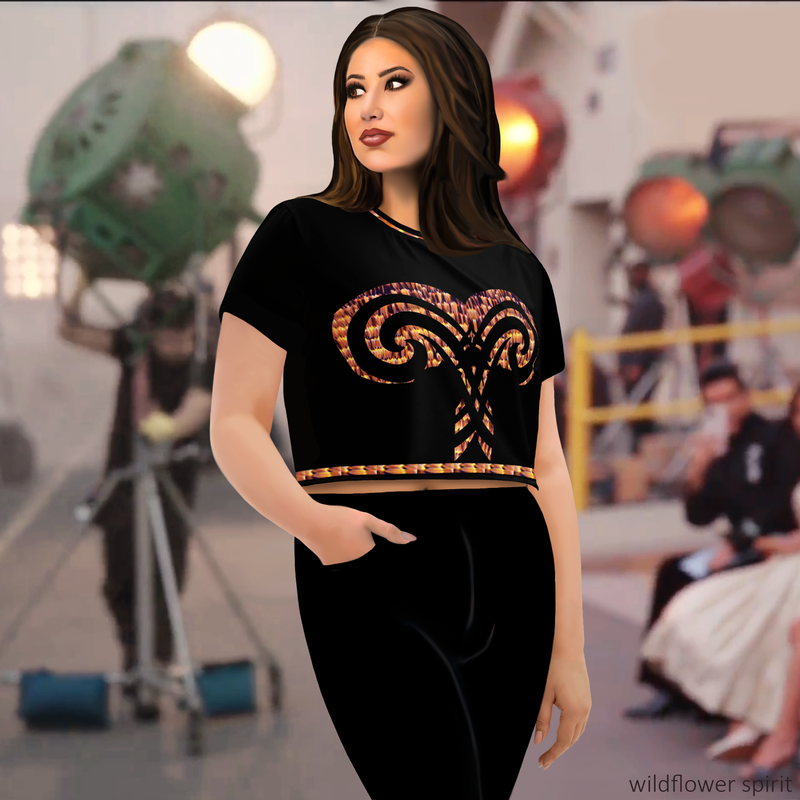 Front view of plus size model wearing DESTINY black crop top with corset inspired design in gold copper tones