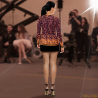Back view of model wearing DESTINY gold copper long sleeve crew top, hip-length fitted silhouette with elongated sleeves, styled over a mini skirt at editorial photo shoot