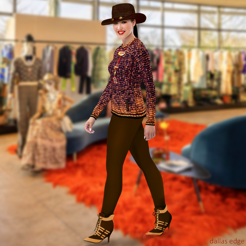 Left view of model wearing DESTINY gold copper long sleeve crew top, hip-length fitted silhouette with elongated sleeves, styled with brown leggings in a luxury boutique