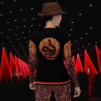 Back view of model wearing black DESTINY long sleeve crew top with snake design in gold copper tones, on a fashion runway